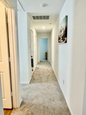 a view of a hallway view with staircase