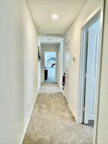 a bedroom with a bed and a mirror on the dresser