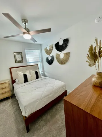 a bedroom with a bed and a painting on the wall