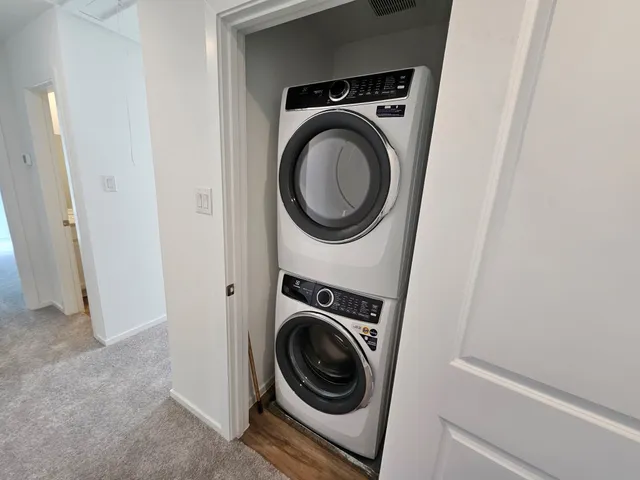 a backyard of a house with plants and large tree