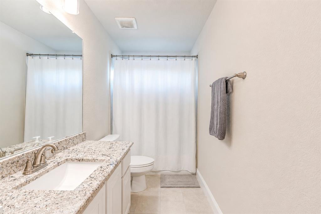 25 Morrison Road Howe, TX 75459 - Photo 23 of 27 Bathroom featuring a vanity with a white countertop and integrated sink, brushed nickel faucet, and overhead bar lighting