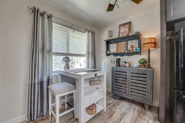 a kitchen with a refrigerator and white cabinets