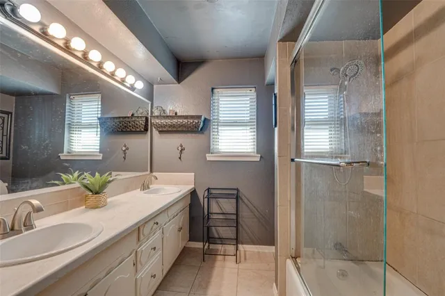 a spacious bathroom with double vanity and a bathtub