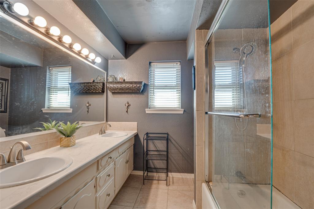 903 Walnut Street Royse City, TX 75189 - Photo 14 of 28 a spacious bathroom with double vanity and a bathtub