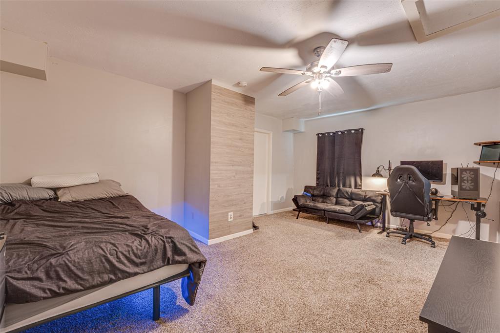 903 Walnut Street Royse City, TX 75189 - Photo 19 of 28 a bedroom with a bed and a chandelier