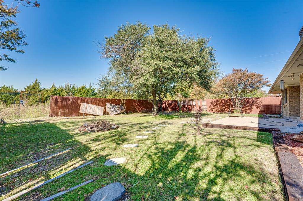 903 Walnut Street Royse City, TX 75189 - Photo 23 of 28 a view of a yard with plants and a fountain
