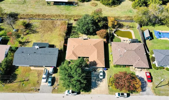 an aerial view of residential houses with outdoor space and swimming pool