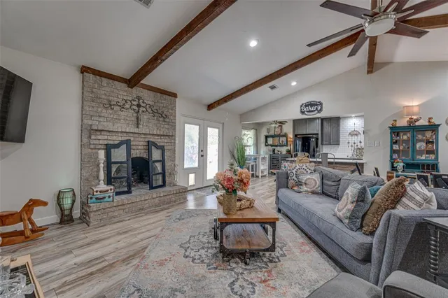 a living room with furniture a fireplace and a flat screen tv
