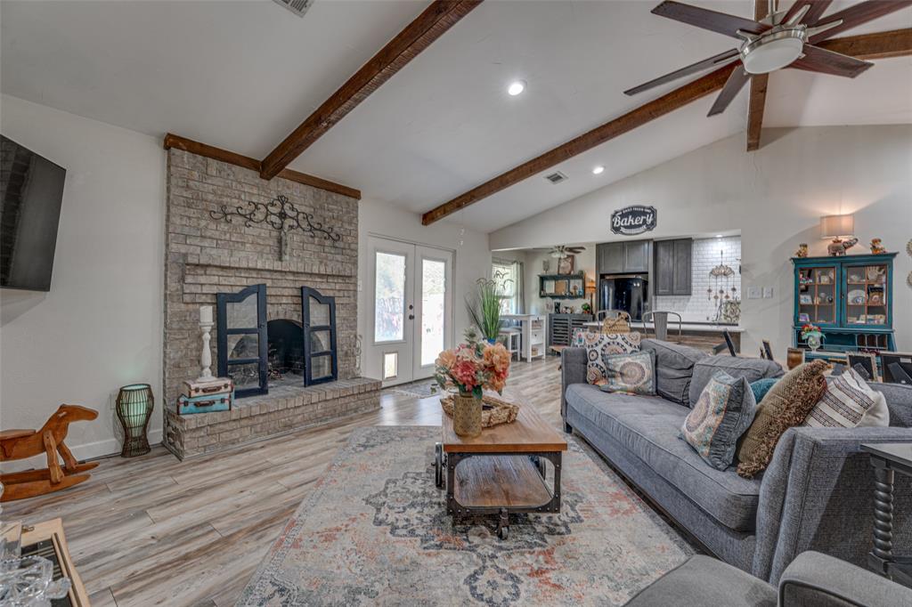 903 Walnut Street Royse City, TX 75189 - Photo 3 of 28 a living room with furniture a fireplace and a flat screen tv
