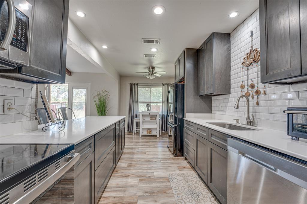 903 Walnut Street Royse City, TX 75189 - Photo 9 of 28 a large kitchen with stainless steel appliances lots of counter space and a sink