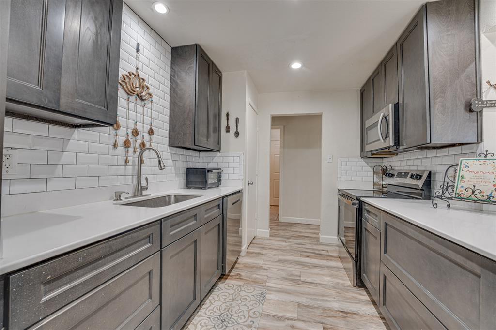 903 Walnut Street Royse City, TX 75189 - Photo 10 of 28 a kitchen with a sink stove and cabinets