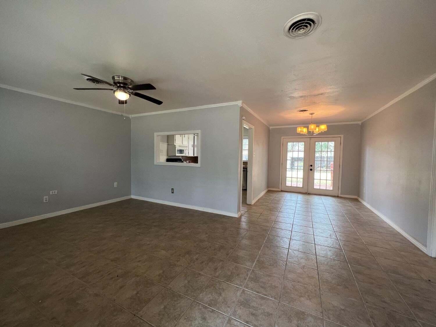 2314 35th Street Lubbock, TX 79412 - Photo 3 of 9 wooden floor in an empty room with a window
