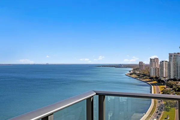 a living room with furniture a chandelier and a large window