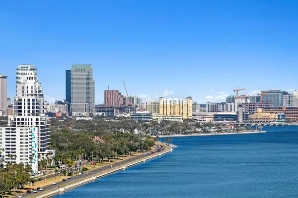 a view of a dining room with furniture a chandelier and wooden floor