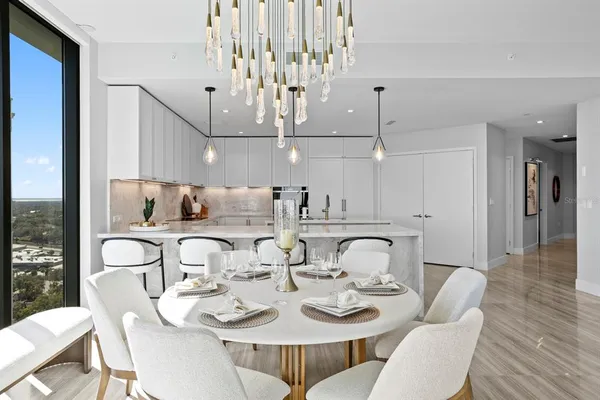 a bedroom with a large bed and a chandelier