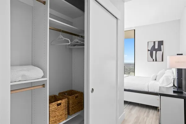 a dining room with furniture and a mirror