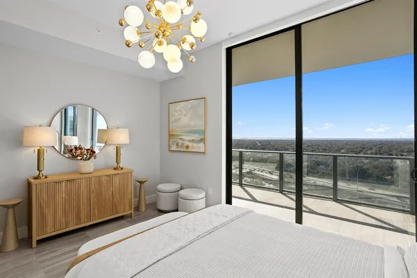 a bedroom with a bed and a chandelier