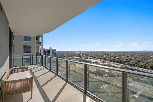 a view of an empty room with wooden floor and a sink