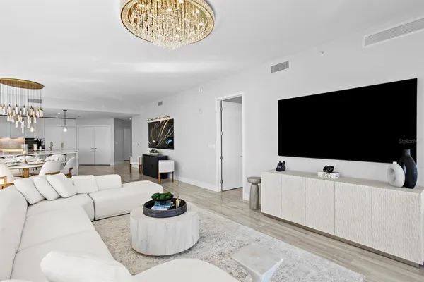 a living room with furniture and a potted plant