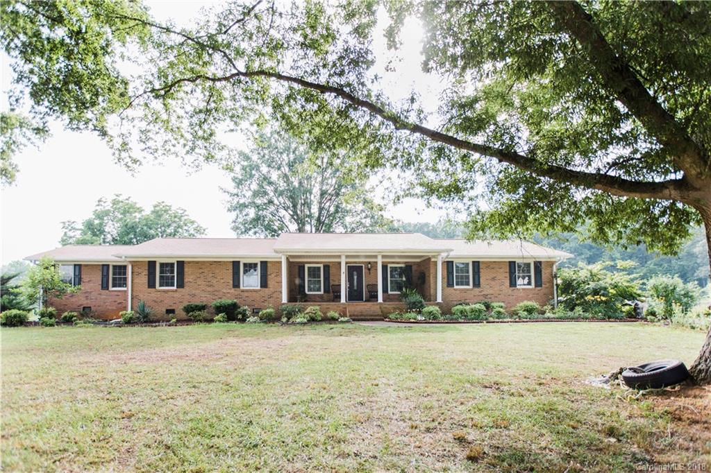 9225 Belt Road Midland, NC 28107 - Photo 1 of 14 a front view of a house with a yard table and chairs