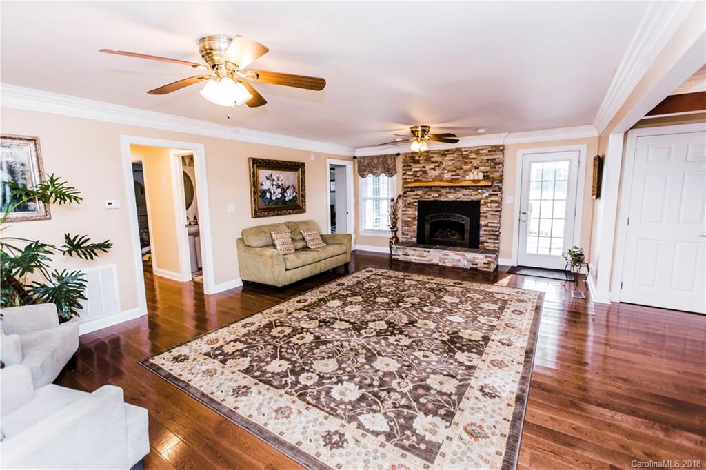 9225 Belt Road Midland, NC 28107 - Photo 3 of 14 a living room with furniture a fireplace and a chandelier