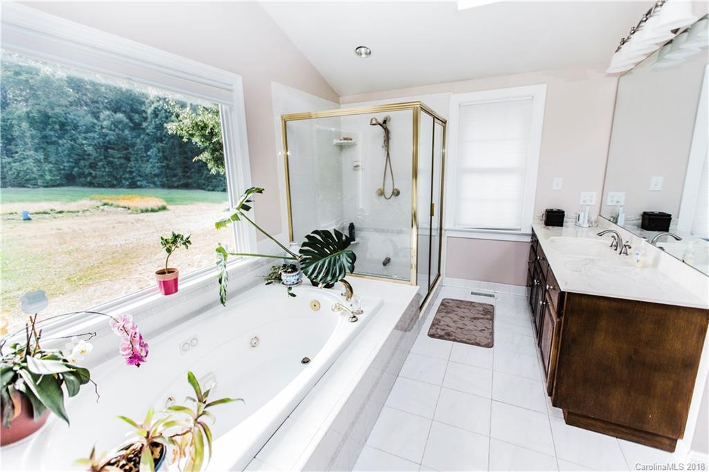 9225 Belt Road Midland, NC 28107 - Photo 8 of 14 a bath room with a bathtub and a sink