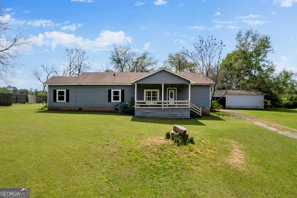 a front view of a house with a garden