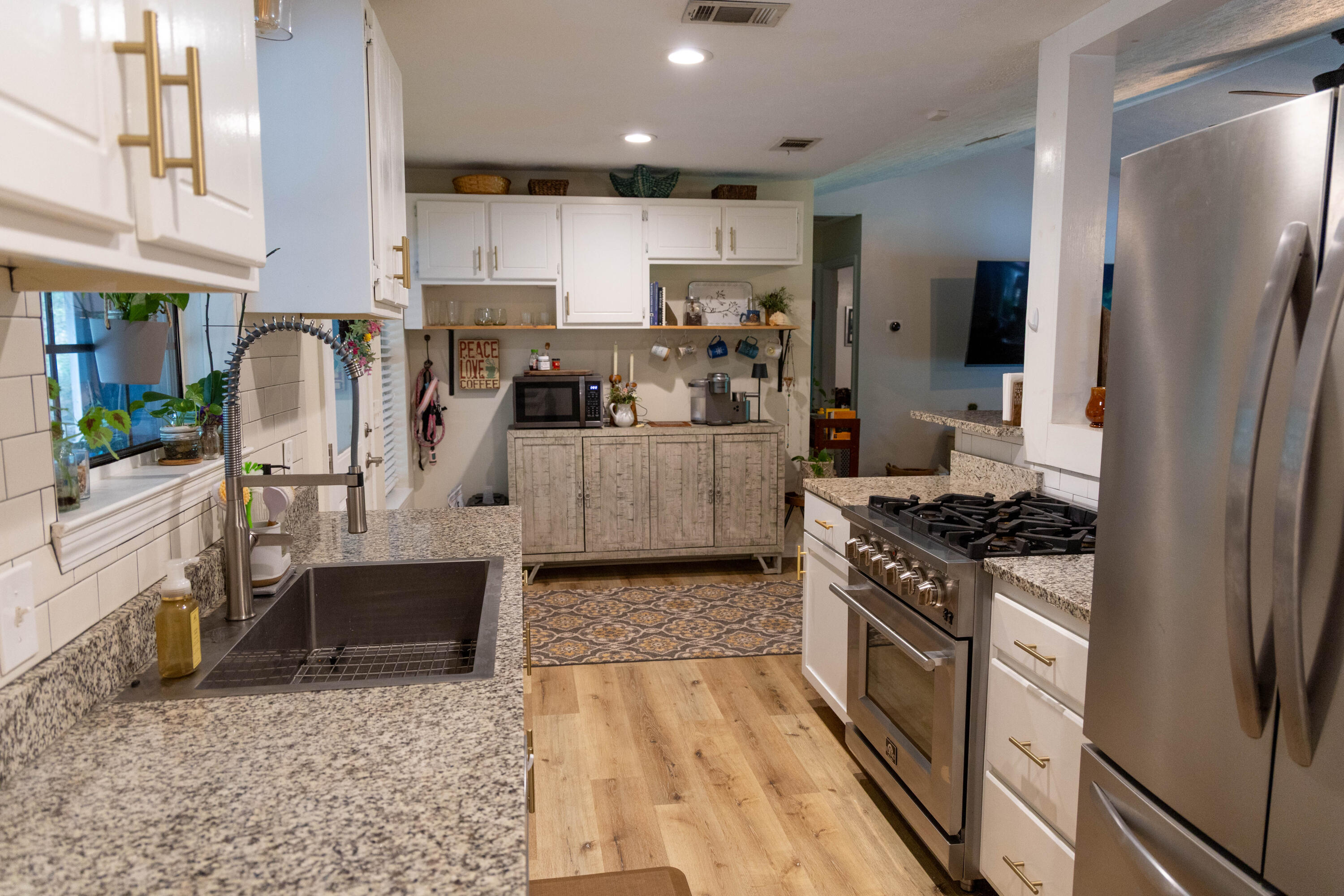 696 Phillips Drive Freeport, FL 32439 - Photo 11 of 49 a kitchen with stainless steel appliances granite countertop a stove top oven a sink dishwasher a refrigerator and cabinets