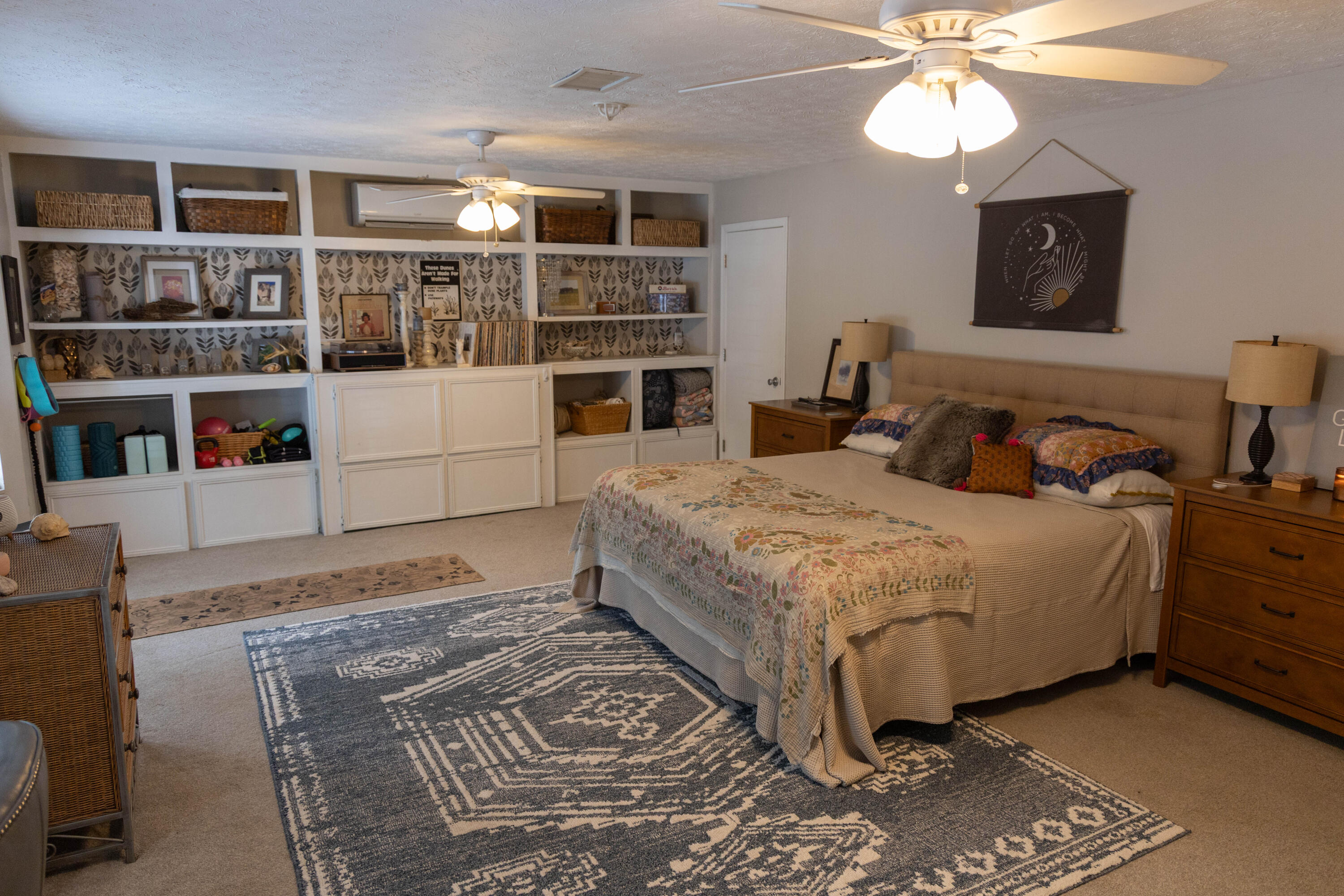 696 Phillips Drive Freeport, FL 32439 - Photo 14 of 49 a bedroom with a bed cabinets and book shelf