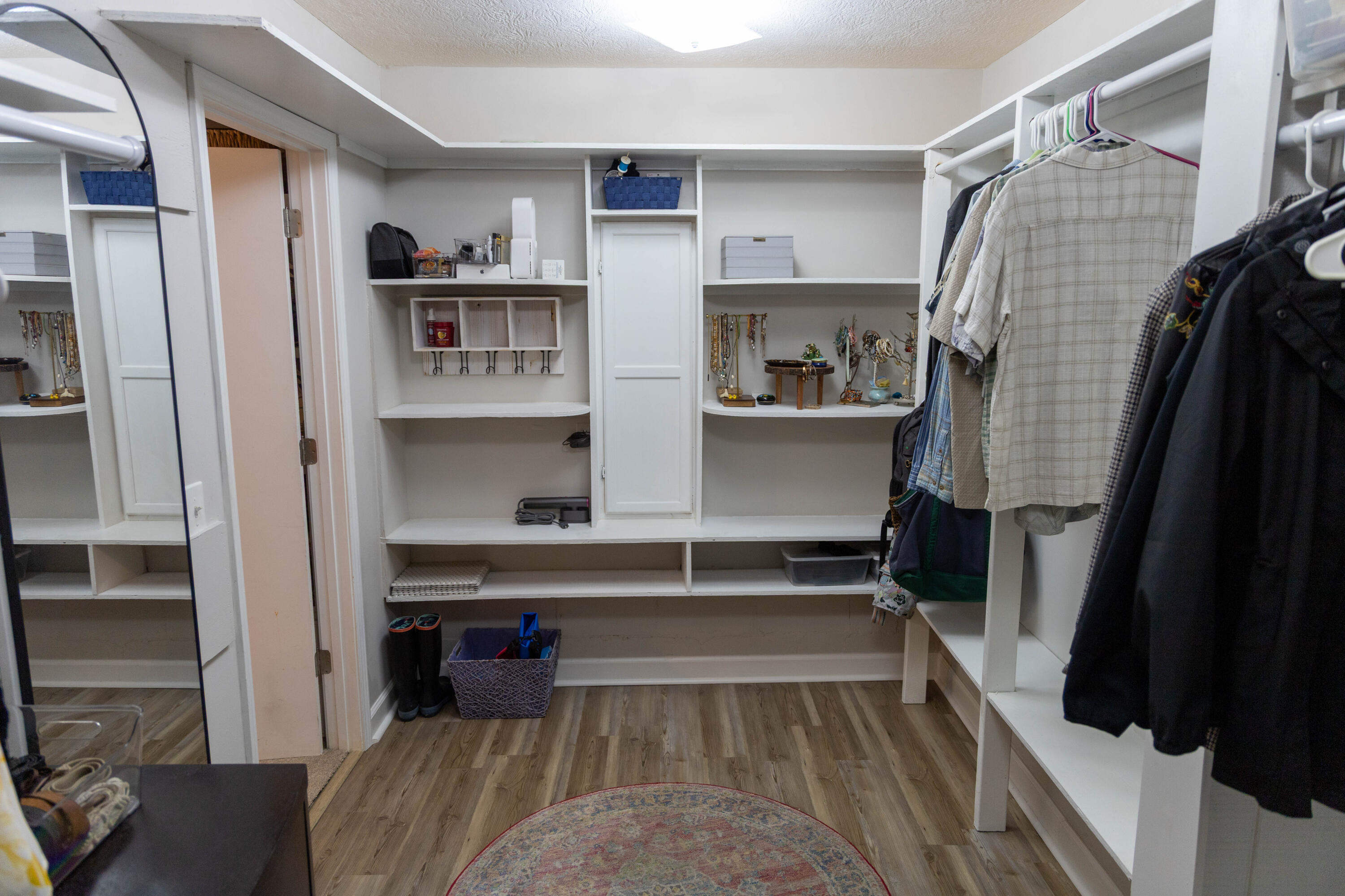 696 Phillips Drive Freeport, FL 32439 - Photo 17 of 49 a view of walk in closet with clothes and shoes