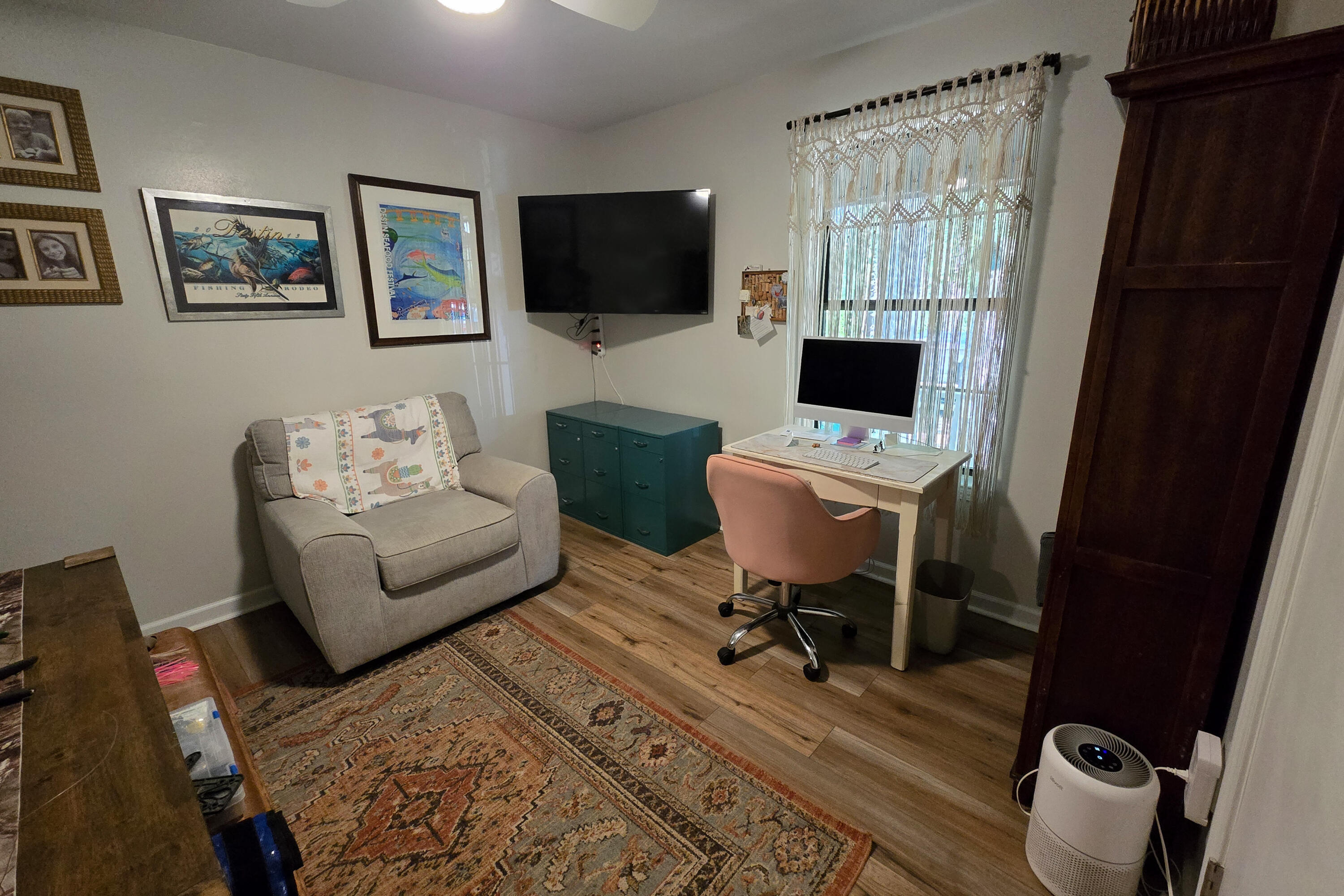696 Phillips Drive Freeport, FL 32439 - Photo 24 of 49 a living room with furniture a flat screen tv and a window