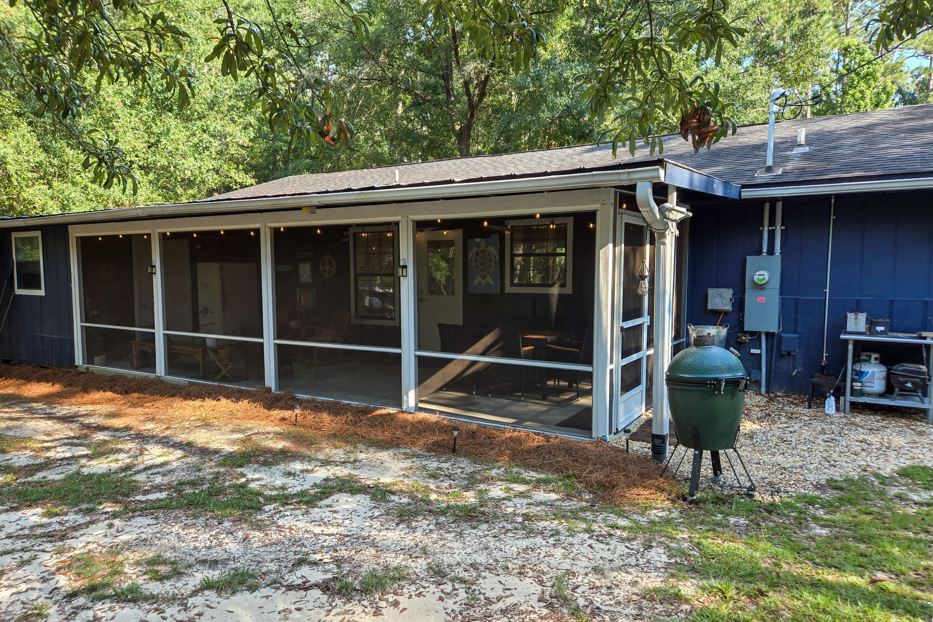 696 Phillips Drive Freeport, FL 32439 - Photo 30 of 49 a view of a backyard with table and chairs and wooden fence