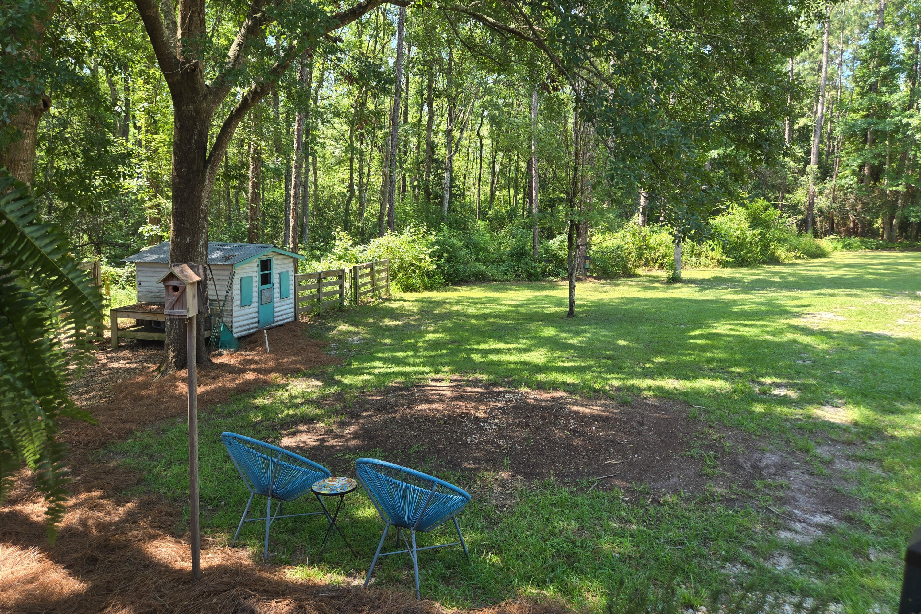 696 Phillips Drive Freeport, FL 32439 - Photo 36 of 49 a backyard of a house with table and chairs