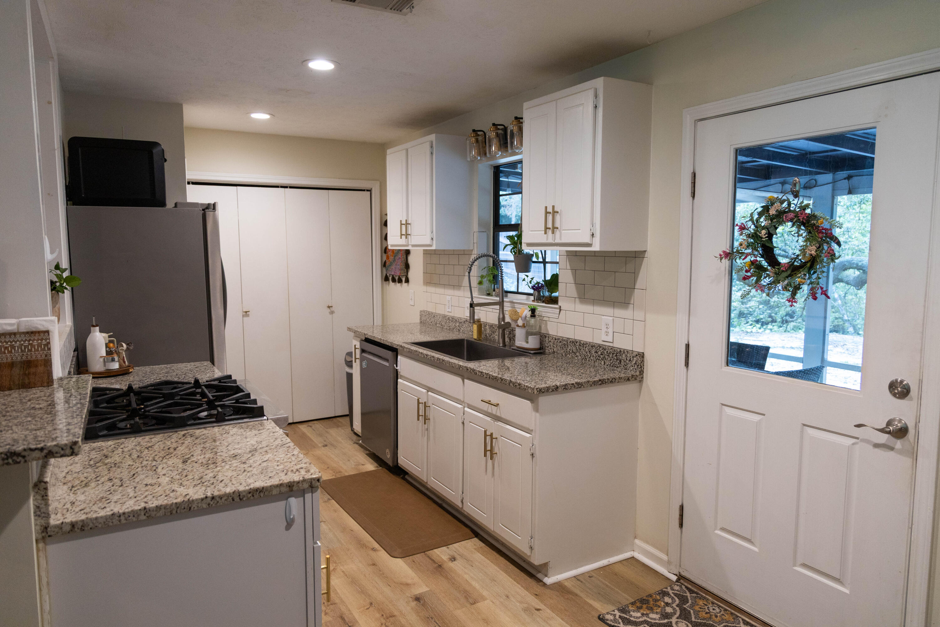 696 Phillips Drive Freeport, FL 32439 - Photo 8 of 49 a kitchen with stainless steel appliances granite countertop a sink stove and refrigerator