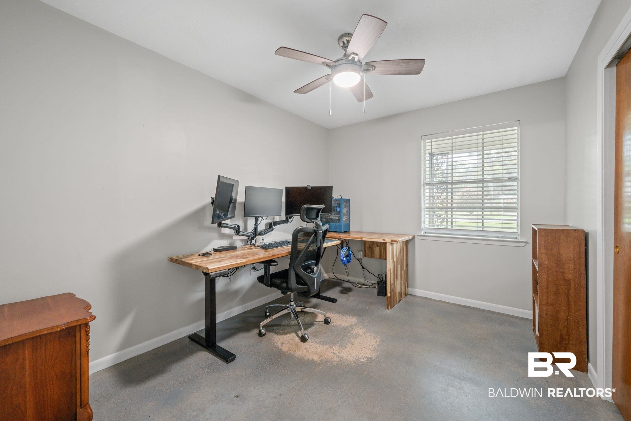 621 Ann Street Saraland, AL 36571 - Photo 12 of 21 Home office with concrete floors and ceiling fan