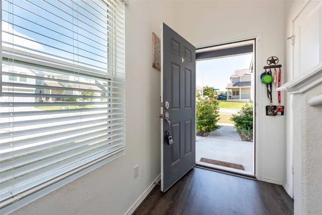 a view of a hallway with wooden floor and glass door