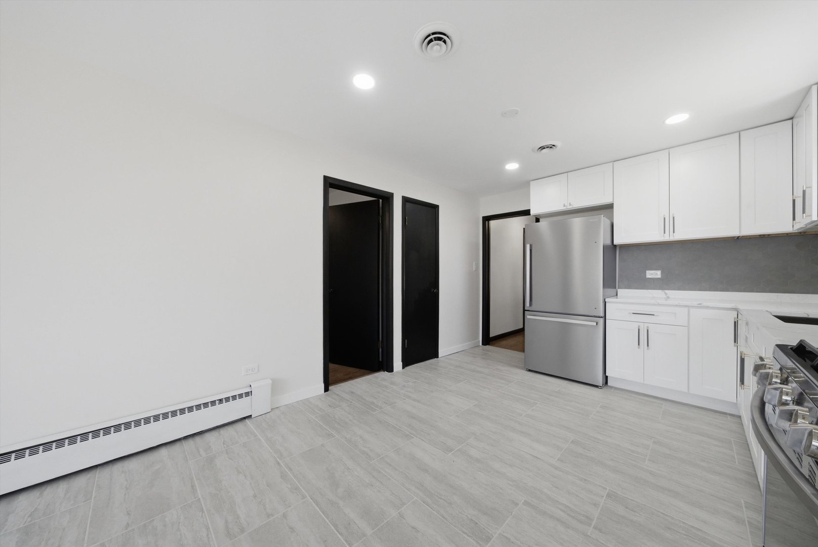 3907 West Marquette Road Chicago, IL 60629 - Photo 13 of 32 a view of a kitchen with refrigerator and white cabinets