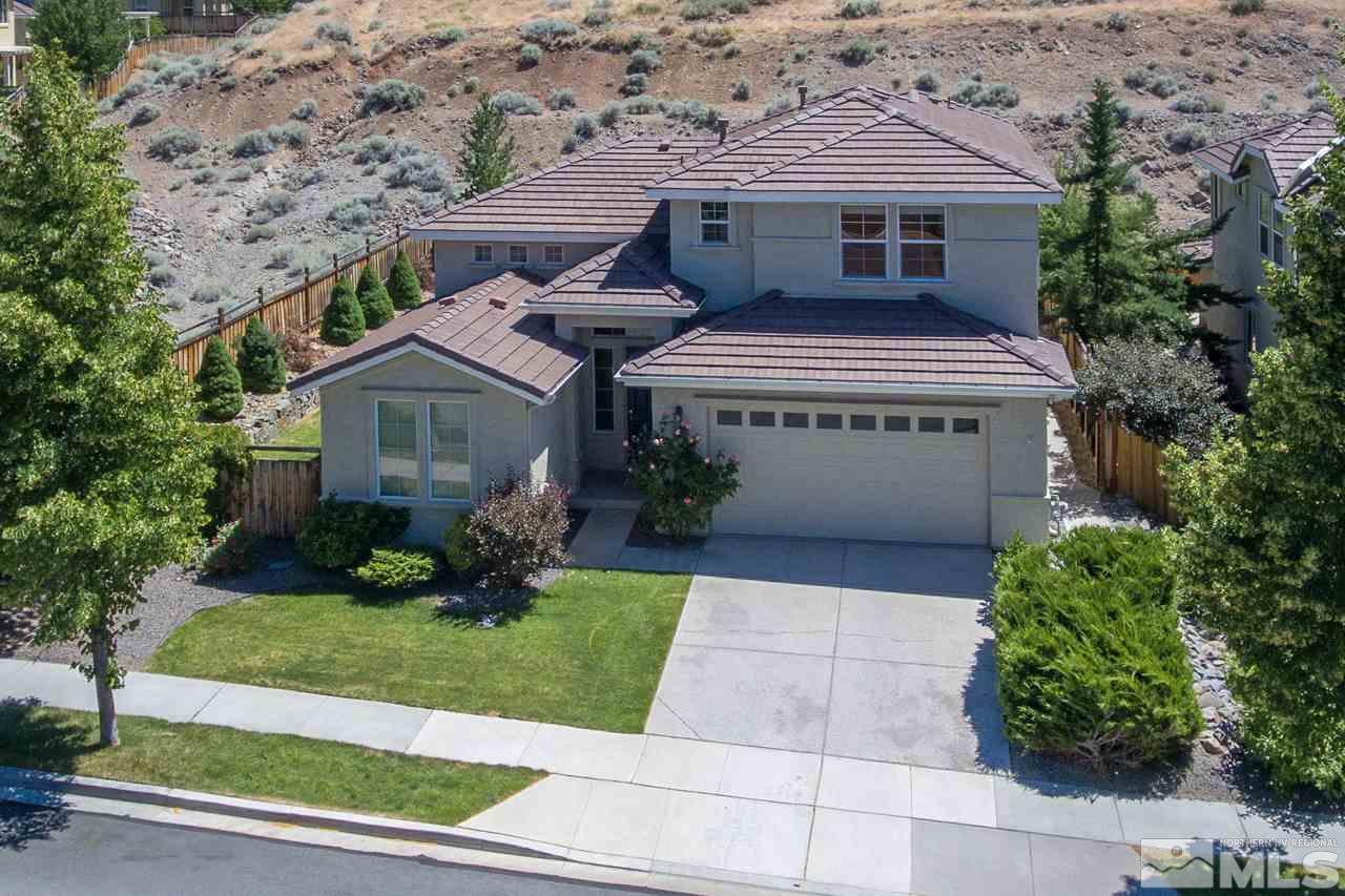 2847 Falcon Ridge Drive Sparks, NV 89436 - Photo 1 of 1 a front view of a house with a yard and garage
