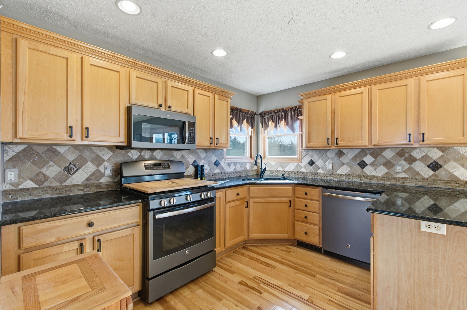 2216 North 2929th Road Marseilles, IL 61341 - Photo 15 of 49 a kitchen with stainless steel appliances granite countertop wooden cabinets granite counter tops and a window