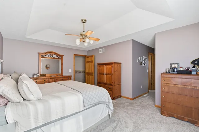 a bedroom with furniture and a chandelier
