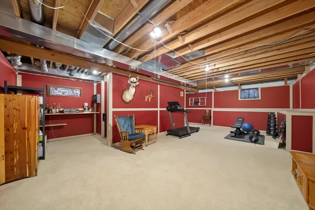 a view of a storage & utility room with fridge and racks