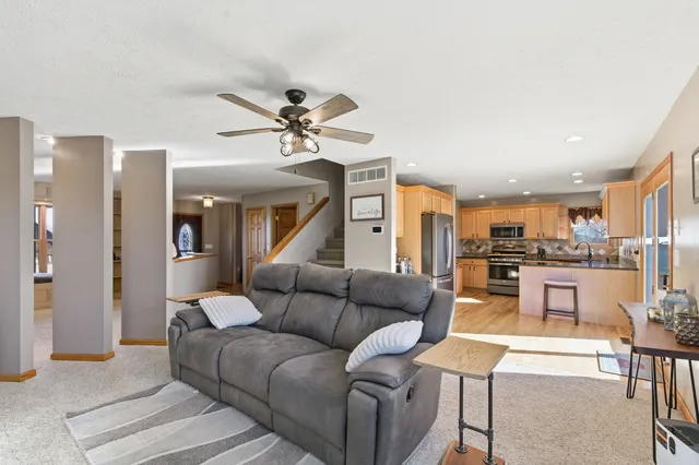 a kitchen with stainless steel appliances granite countertop a refrigerator a stove and a wooden cabinets