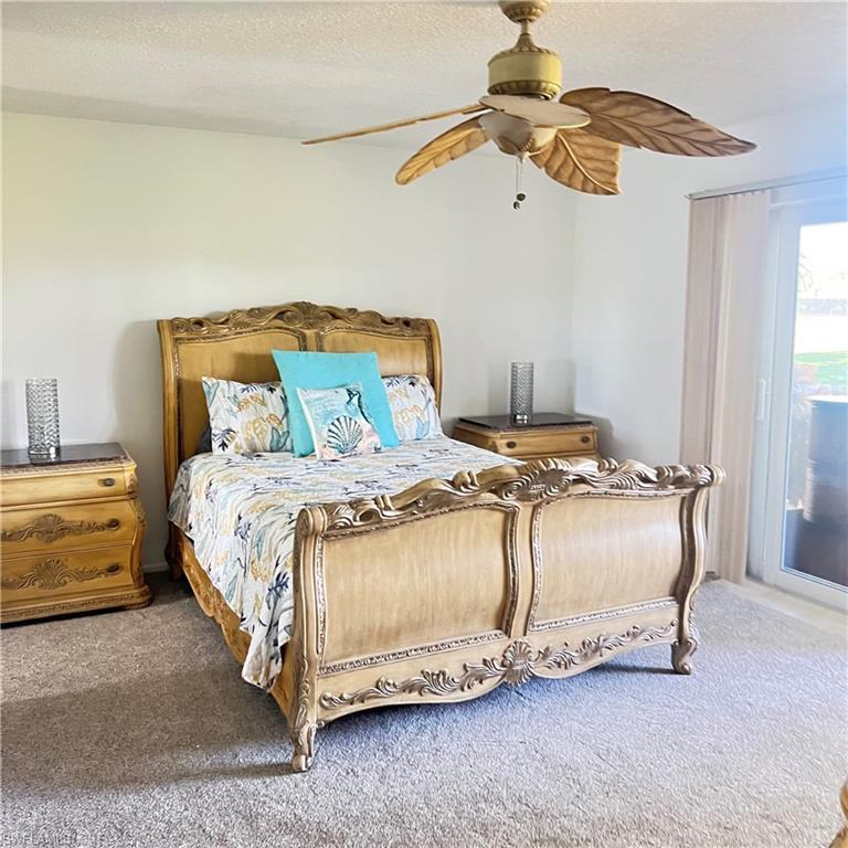 197 Harrison Road, Unit 3 Naples, FL 34112 - Photo 10 of 14 Bedroom with access to exterior, a textured ceiling, ceiling fan, and carpet