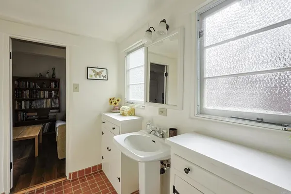 a bathroom with a sink a toilet and a mirror