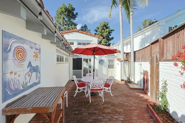 a view of a flower pot with a plant and a wooden floor
