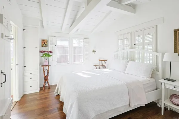 a spacious bedroom with a bed and glass door