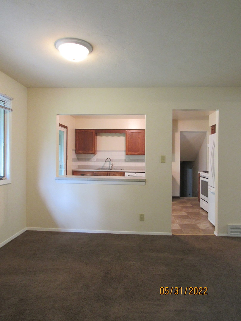 817 Normal Road DeKalb, IL 60115 - Photo 11 of 24 a view of an empty room with wooden floor and a window
