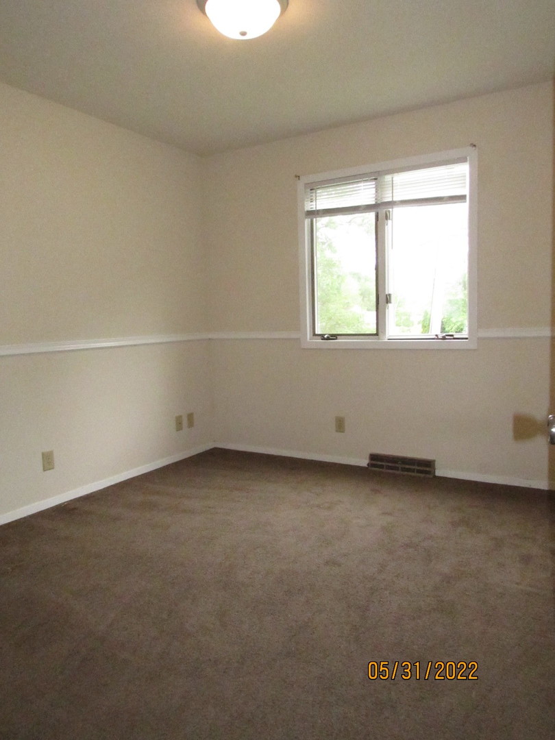 817 Normal Road DeKalb, IL 60115 - Photo 16 of 24 an empty room with a window