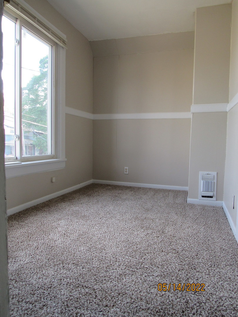 817 Normal Road DeKalb, IL 60115 - Photo 17 of 24 an empty room with a window