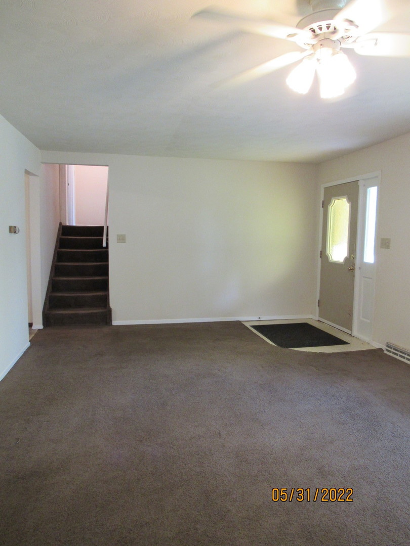817 Normal Road DeKalb, IL 60115 - Photo 4 of 24 wooden floor in an empty room with a window